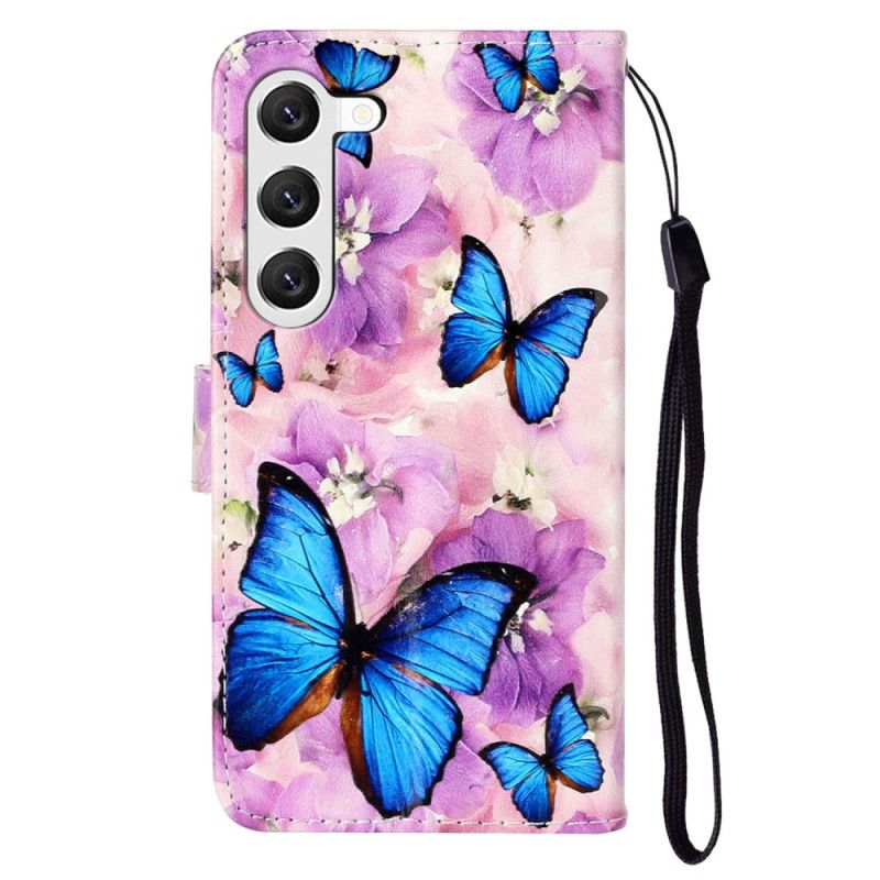 Housse Samsung Galaxy S24 Plus 5G Papillons Bleus et Fleurs Violettes à Lanière