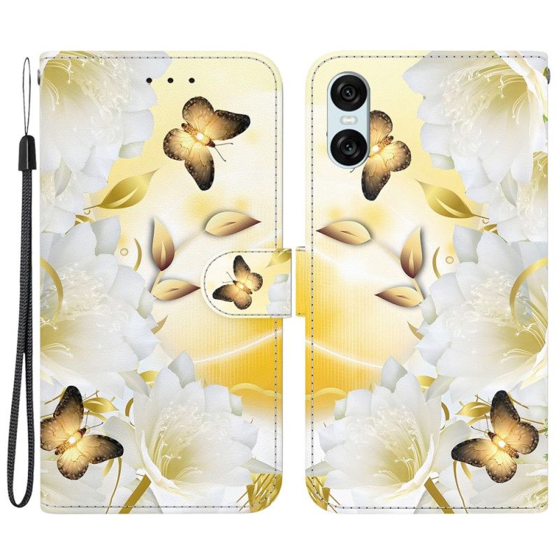 Housse Sony Xperia 10 VI Papillons Dorés et Fleurs Blanches à Lanière