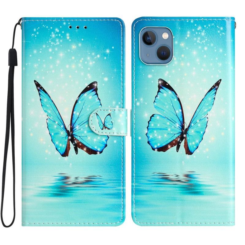 Housse iPhone 15 Papillon Bleu en Vol à Lanière