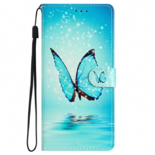 Housse iPhone 16 Papillon Bleu à Lanière